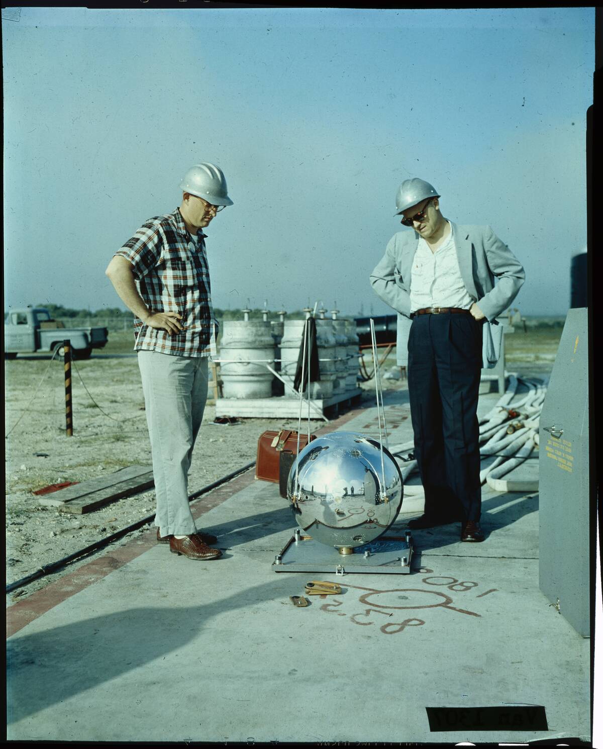 Scientists Working Outdoors on Satellite