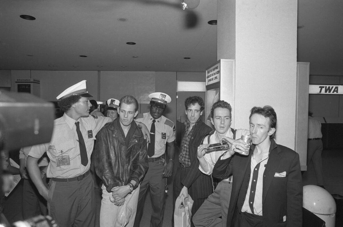 The Clash Standing With Airport Personnel