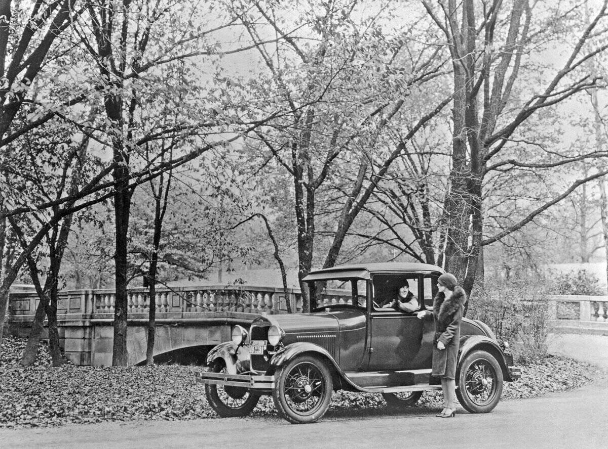 The old Ford car. A Ford Model A Convertible 1927 with two women in the decades typical fashion. The m...