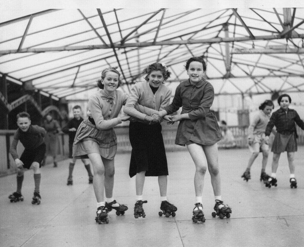 Three young roller skaters on the open air skating rink at Seaburn