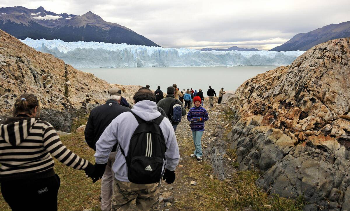 Tourists walk toward the Perito Moreno g
