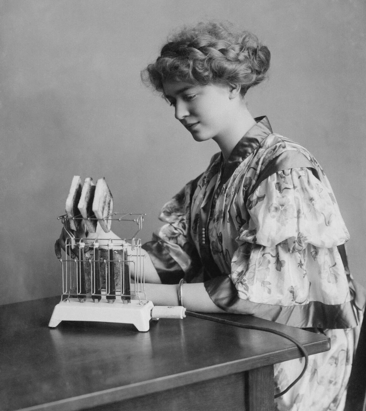 Woman Demonstrates Use of GE Toaster