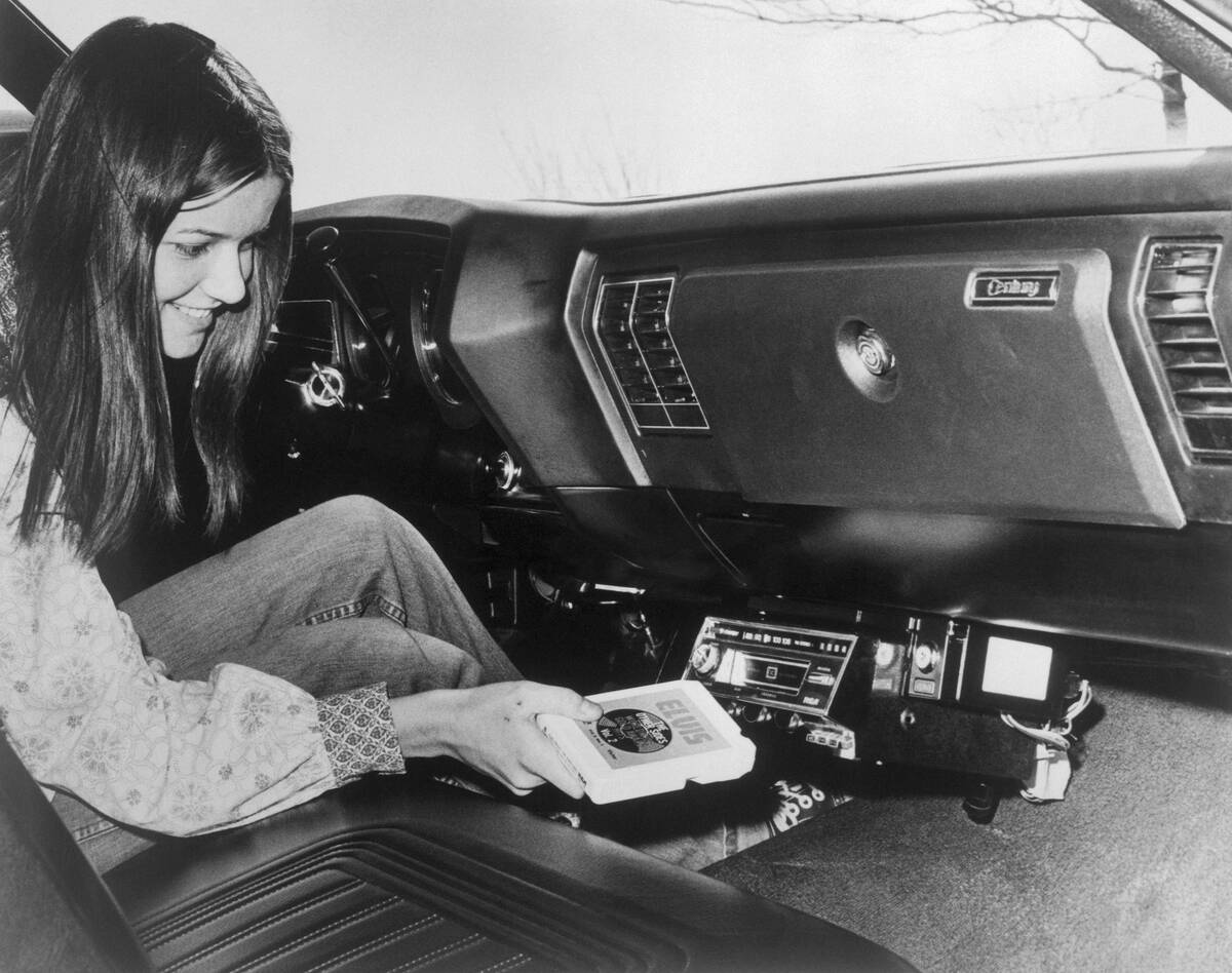 Woman Inserting Eight-Track Tape in Car Stereo