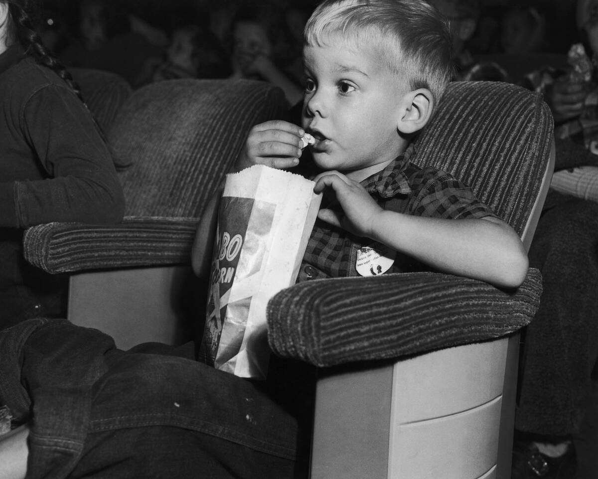 Boy Eating Popcorn at the Movies