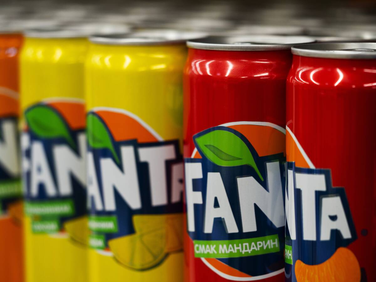 Cans of Fanta are seen on a shelf in a store...