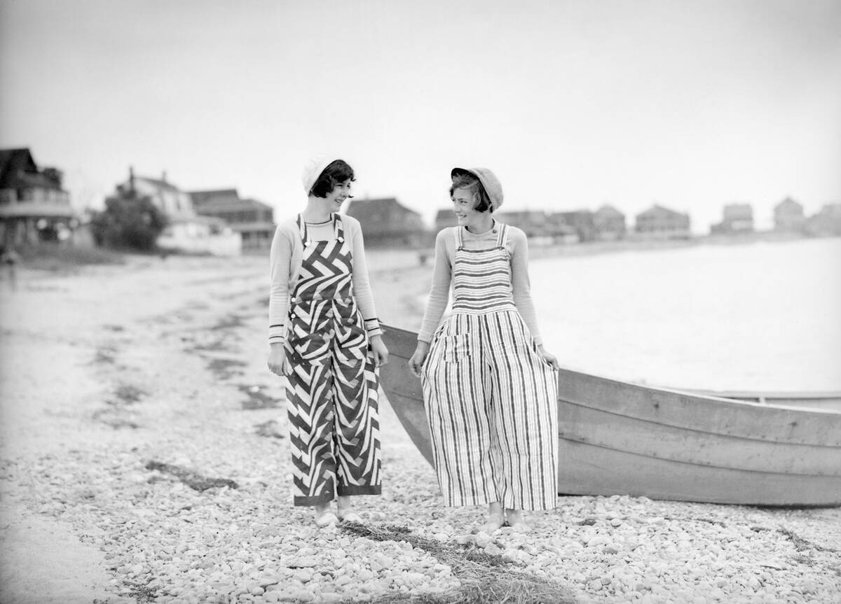 Flappers are fashionable along the beach, ca. 1926.