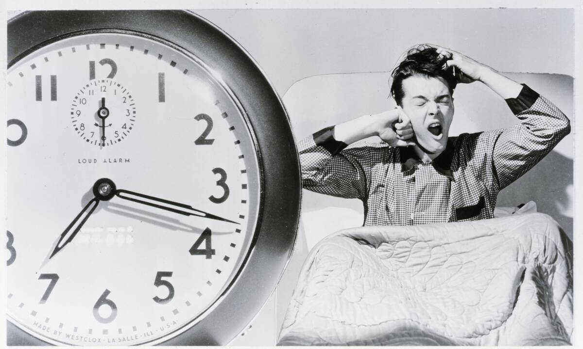 Man Waking Up To Alarm Clock