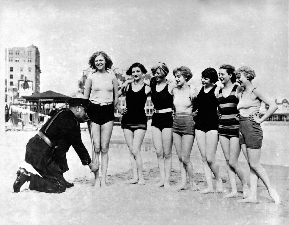 Policeman Measuring Women's Swimming Suits