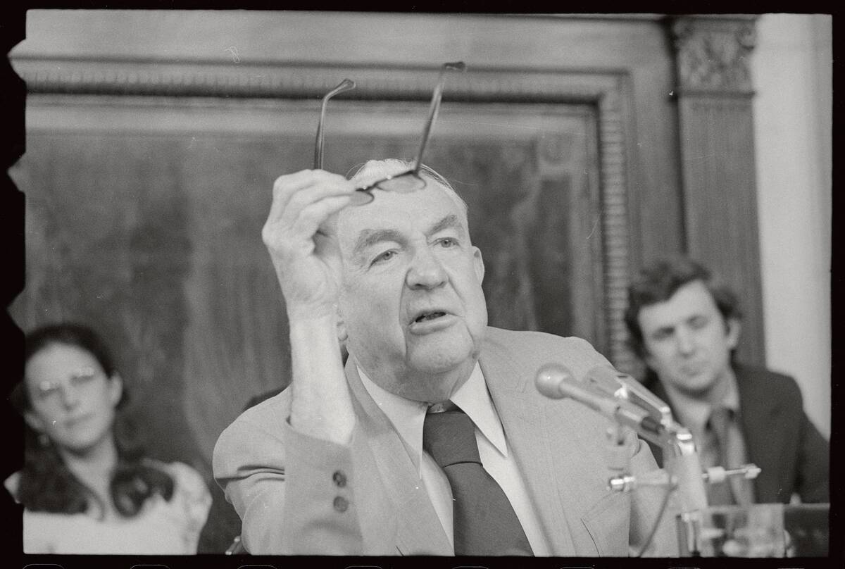 Sam Irving Holding Eyeglasses During Hearing
