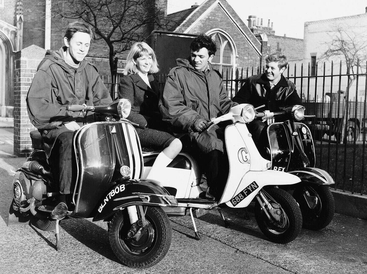 Teenagers following Mod fashion on scooters