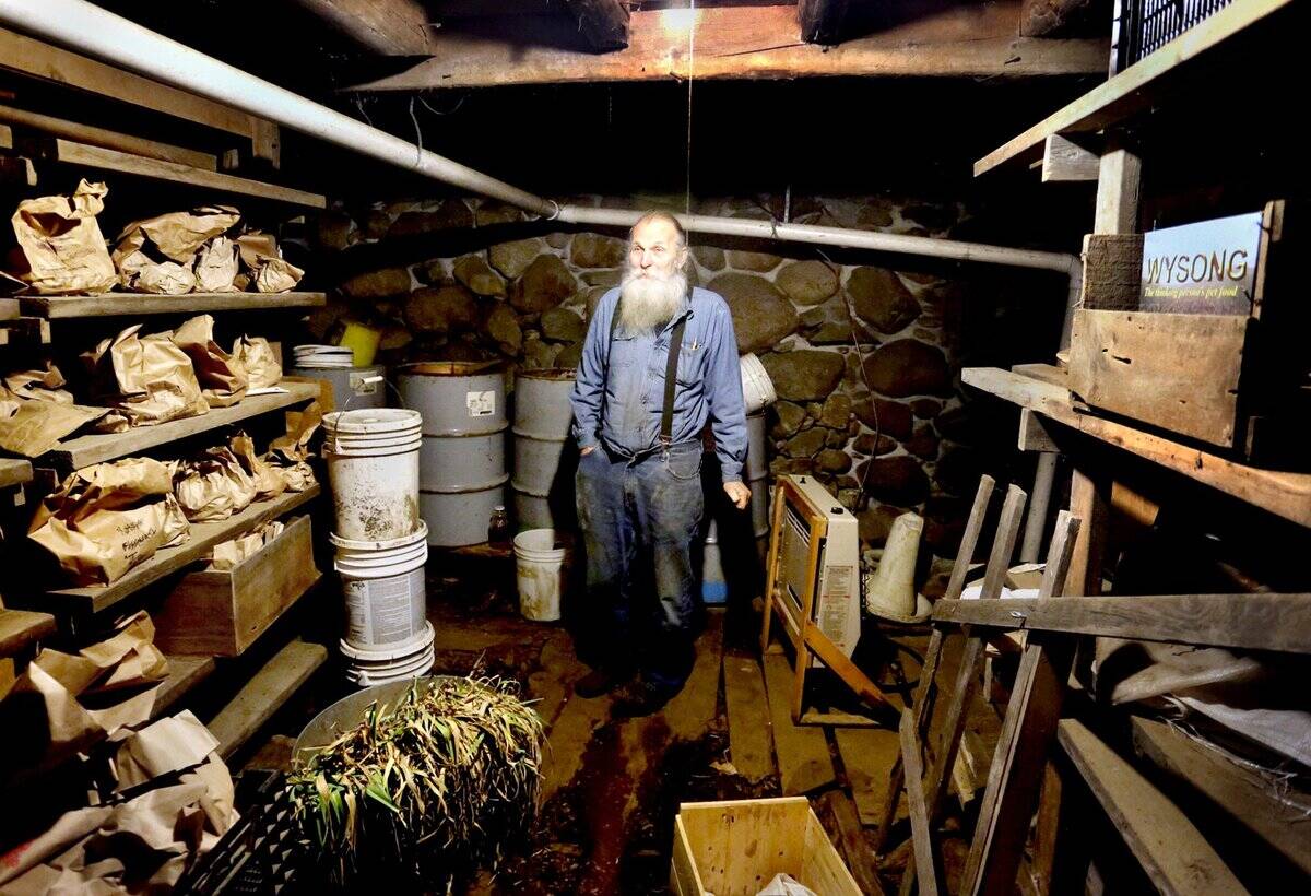 Will Bonsall in his root cellar where he keeps hundreds of different types of potatoes in brown bags
