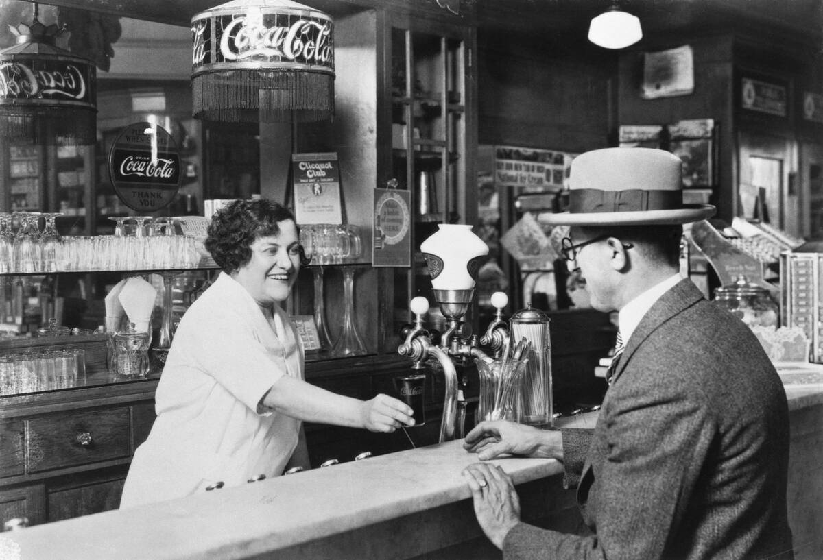 Woman Dispensing Coke At Soda Fountain
