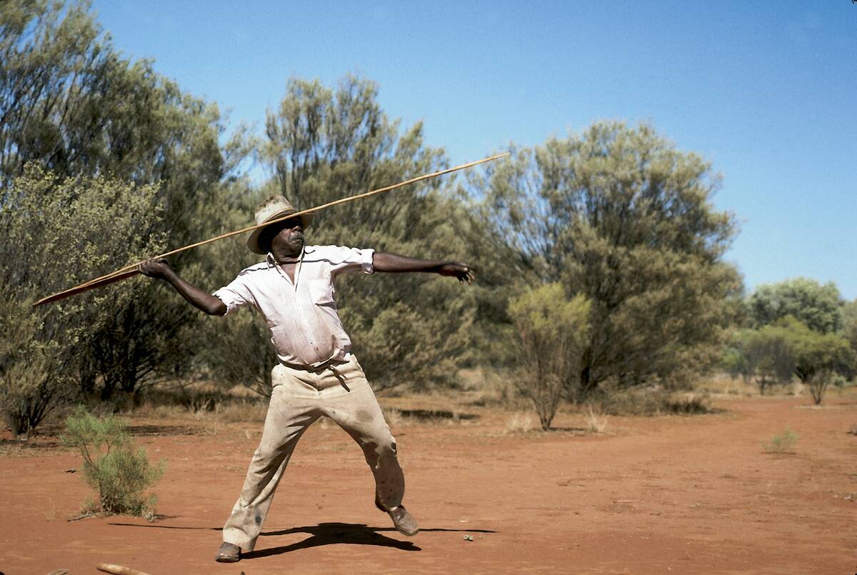 An adult Aborigine male using a throwing slings with a spear in Rod Steinert's Aboriginal Dreamtime Tour