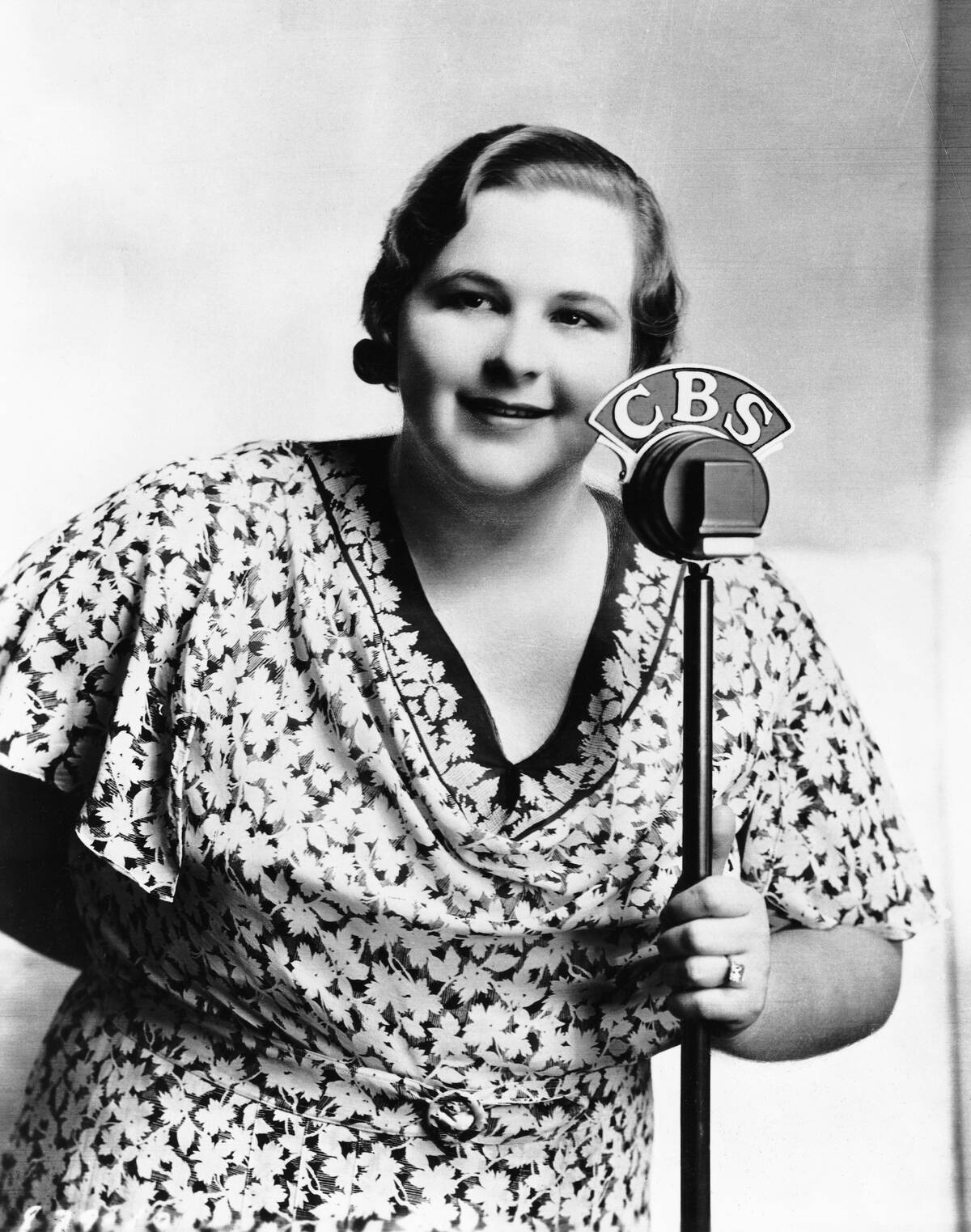 Kate Smith Holding Onto A Microphone