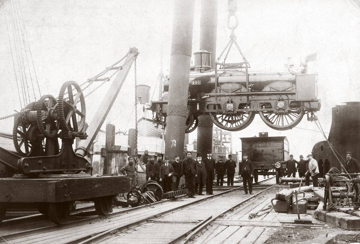 Loading a steam locomotive onto a ship, Newhaven, East Sussex, late 1800s.