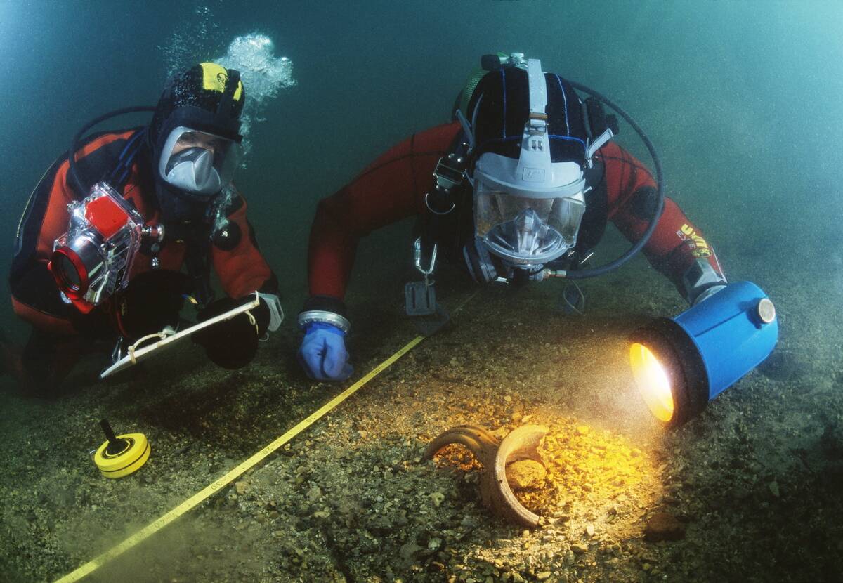 Slovenia - Ljubljanica river - Divers inspecting scattered pieces of pottery