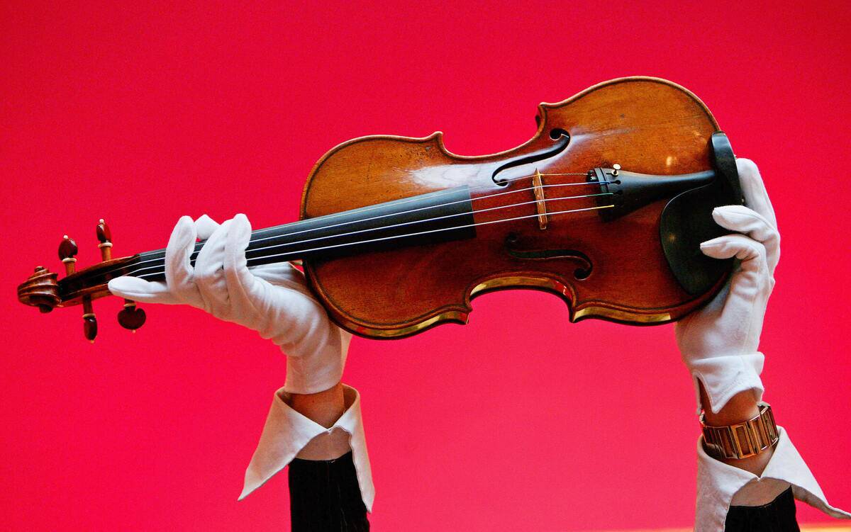 A Christies auction house employee holds...