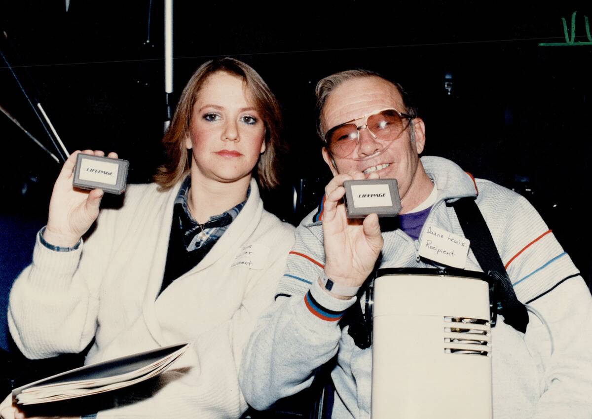 A lifesaver: Doris Stiller; left; and Duane Lewis hold new pagers for transplant patients. Stiller o...