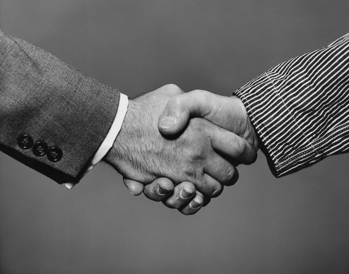 CLOSE-UP OF PEOPLE SHAKING HANDS