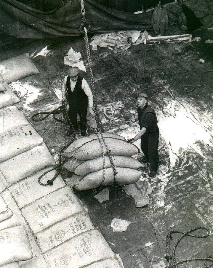 Dockers unloading a cargo of sugar