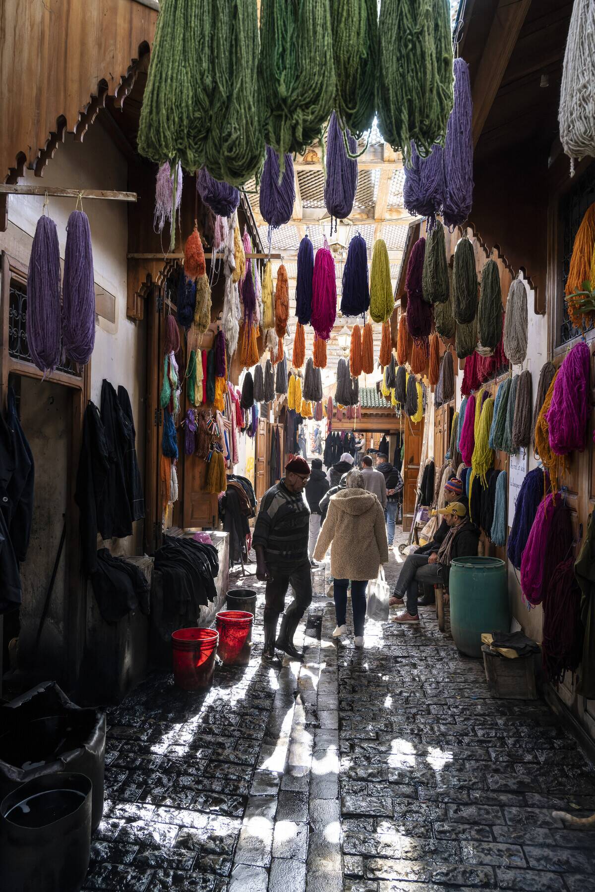 Dyed wool of different colors hanging in a street in the...