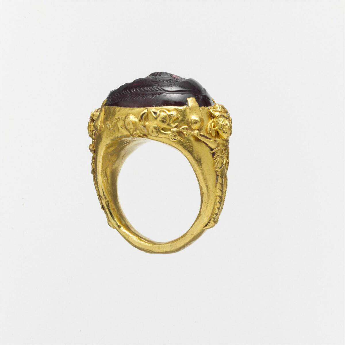 Gold ring with a carnelian or glass intaglio.