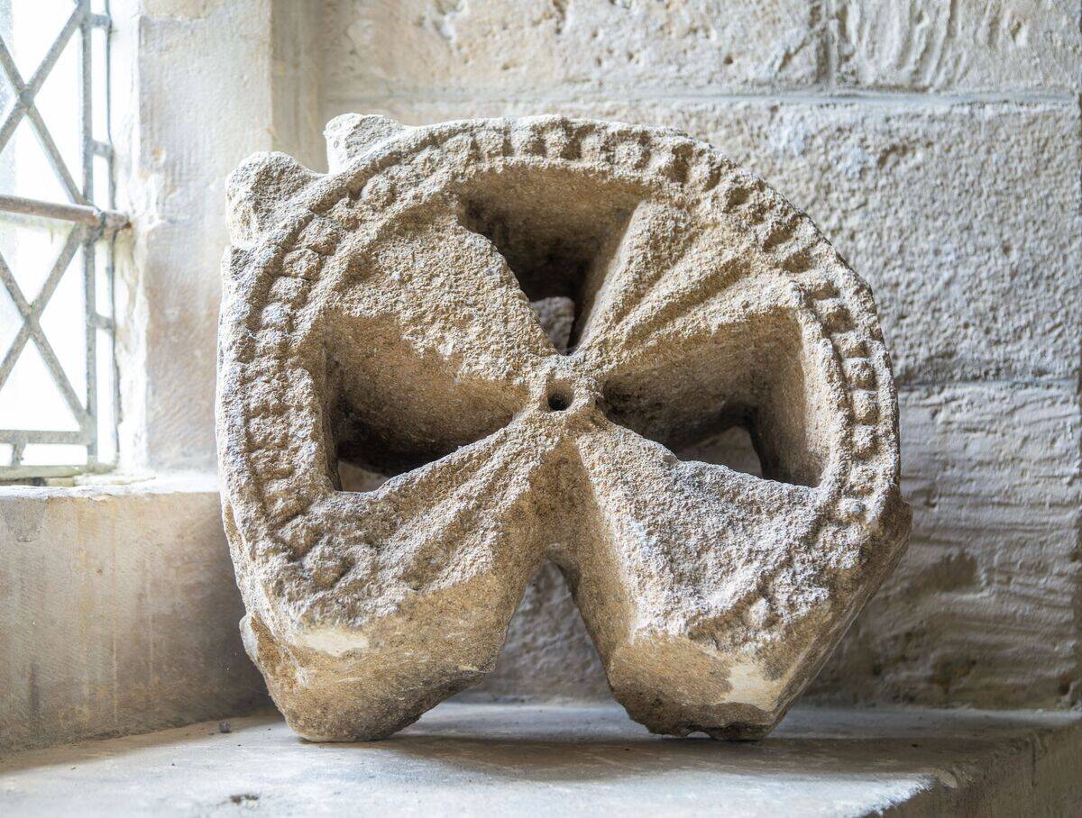 Head of ancient stone cross discovered in churchyard, church of Saint Michael, Yanworth, Gloucestershire, England, UK