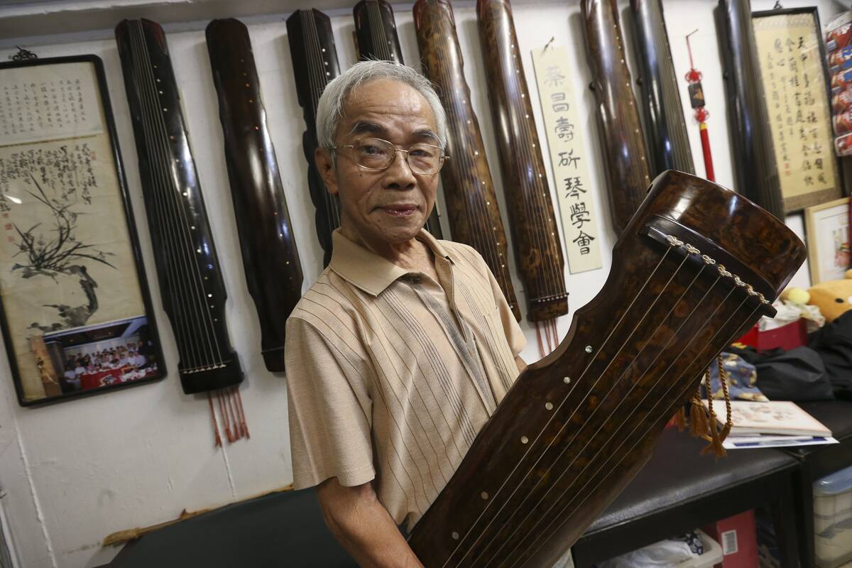 Master instrument maker Choi Cheung-sau, poses with a Guqin, at Choi Fook Kee Musical Instrument Factory in Shek Kip Mei. 03NOV15 [LIFE FEATURES]