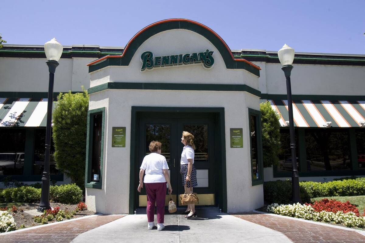 People try to enter a closed Bennigan's restaurant in Santa