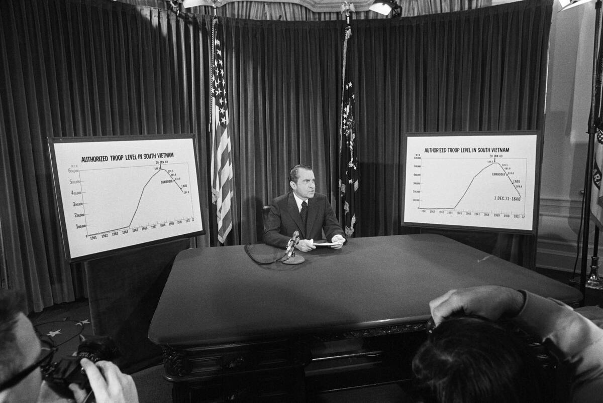 President Nixon Flanked By Charts