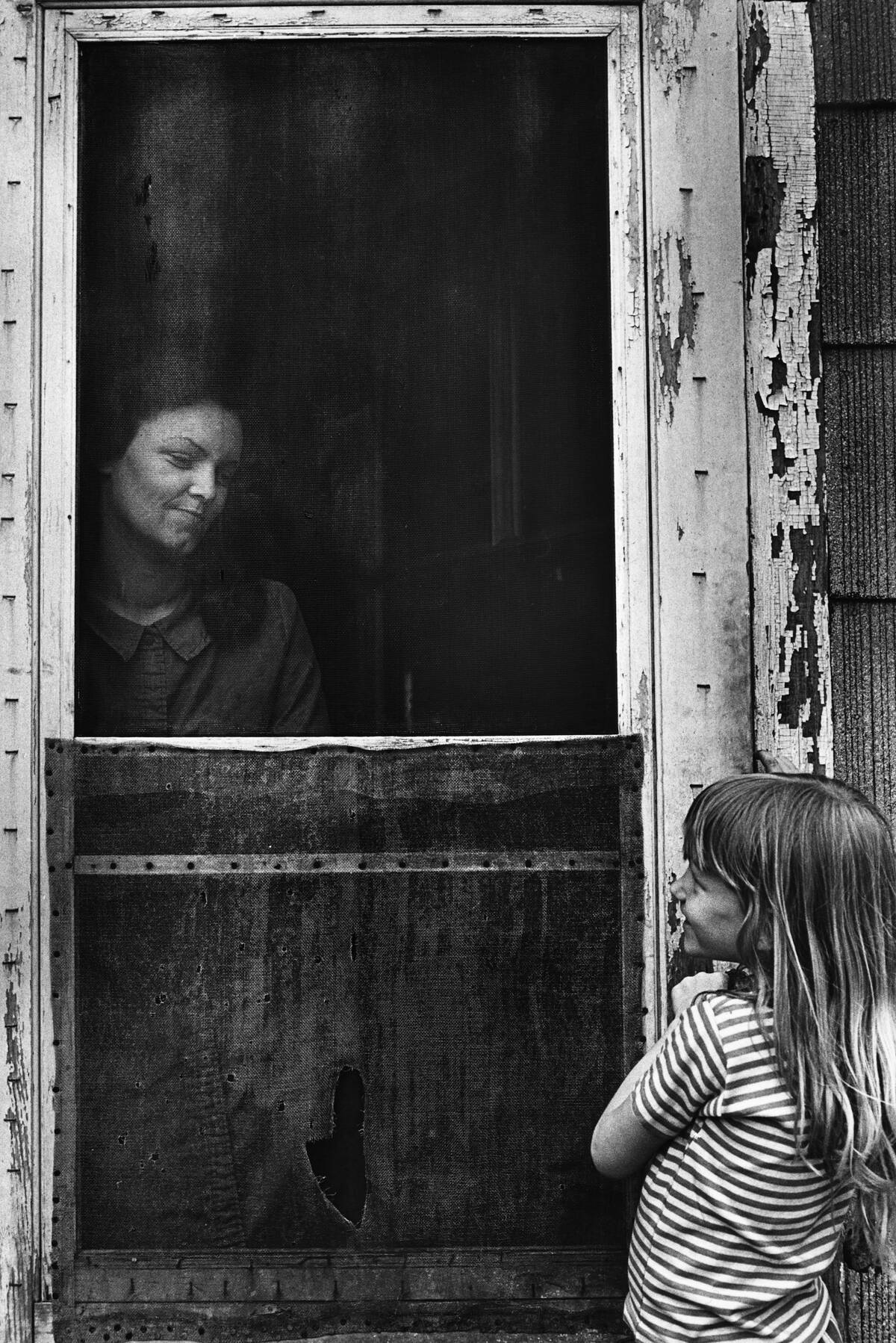Smiling Through Screen Door