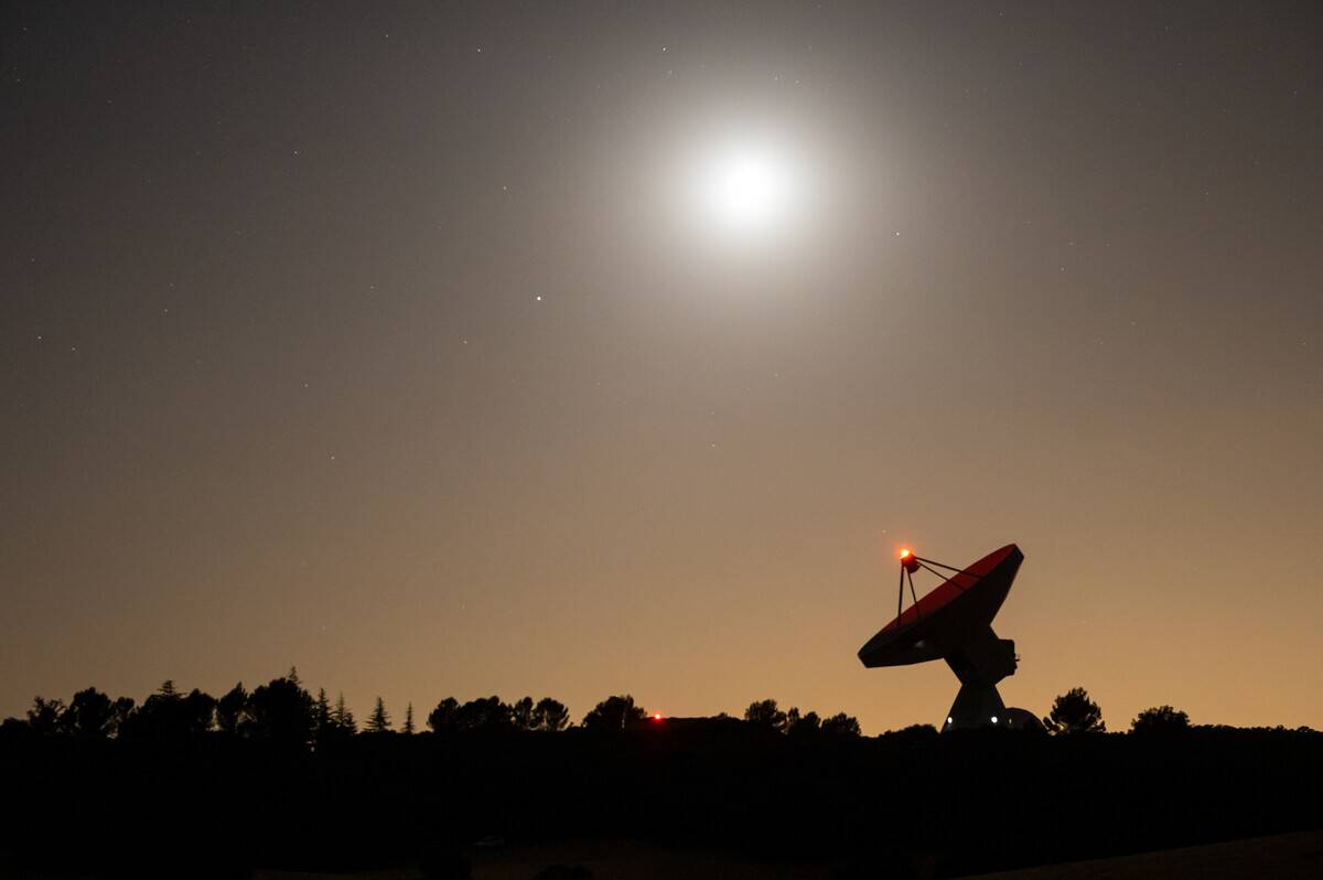 The moon and Spica (brightest star in the sky) is seen...