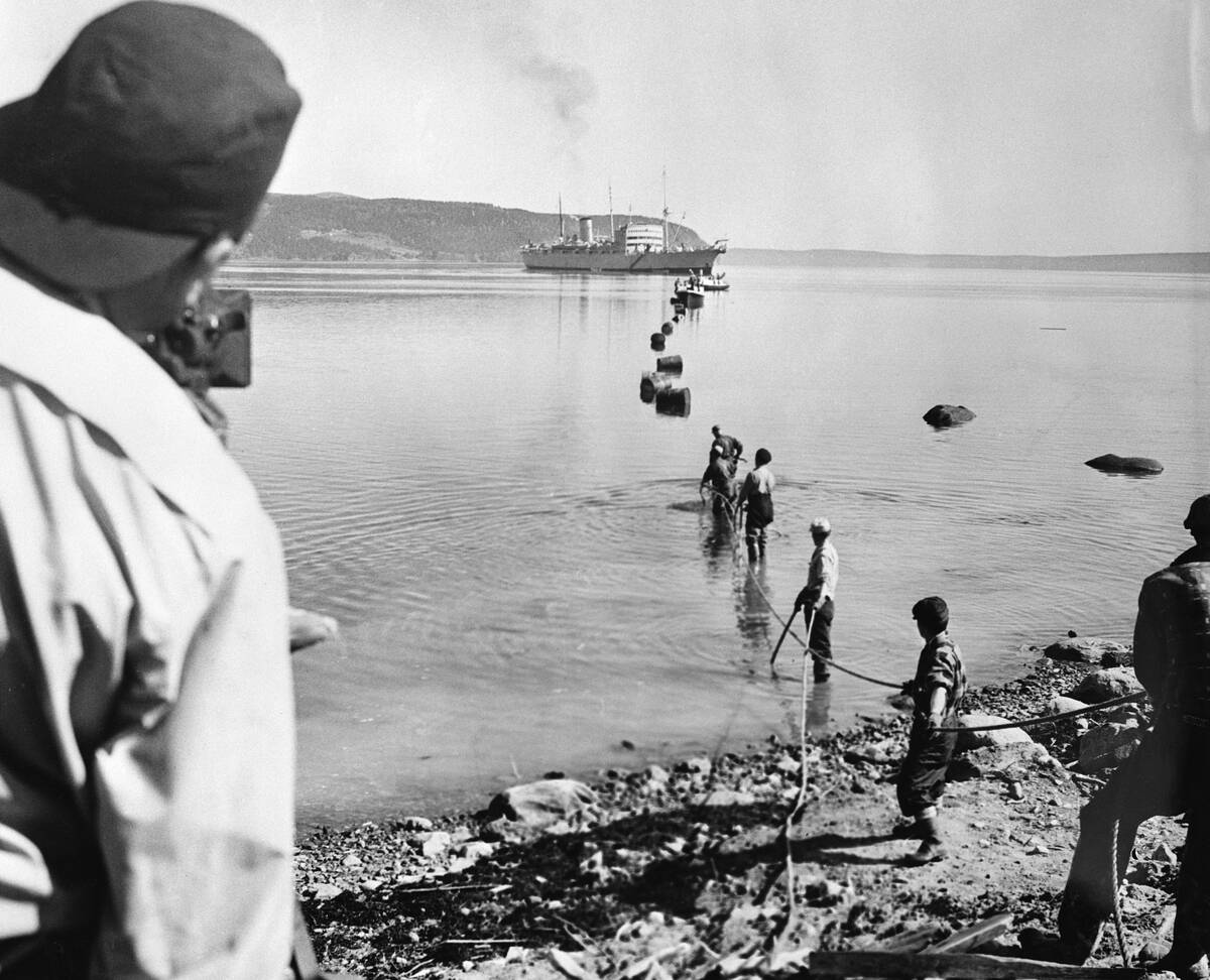 Workmen Pulling Cable Ashore