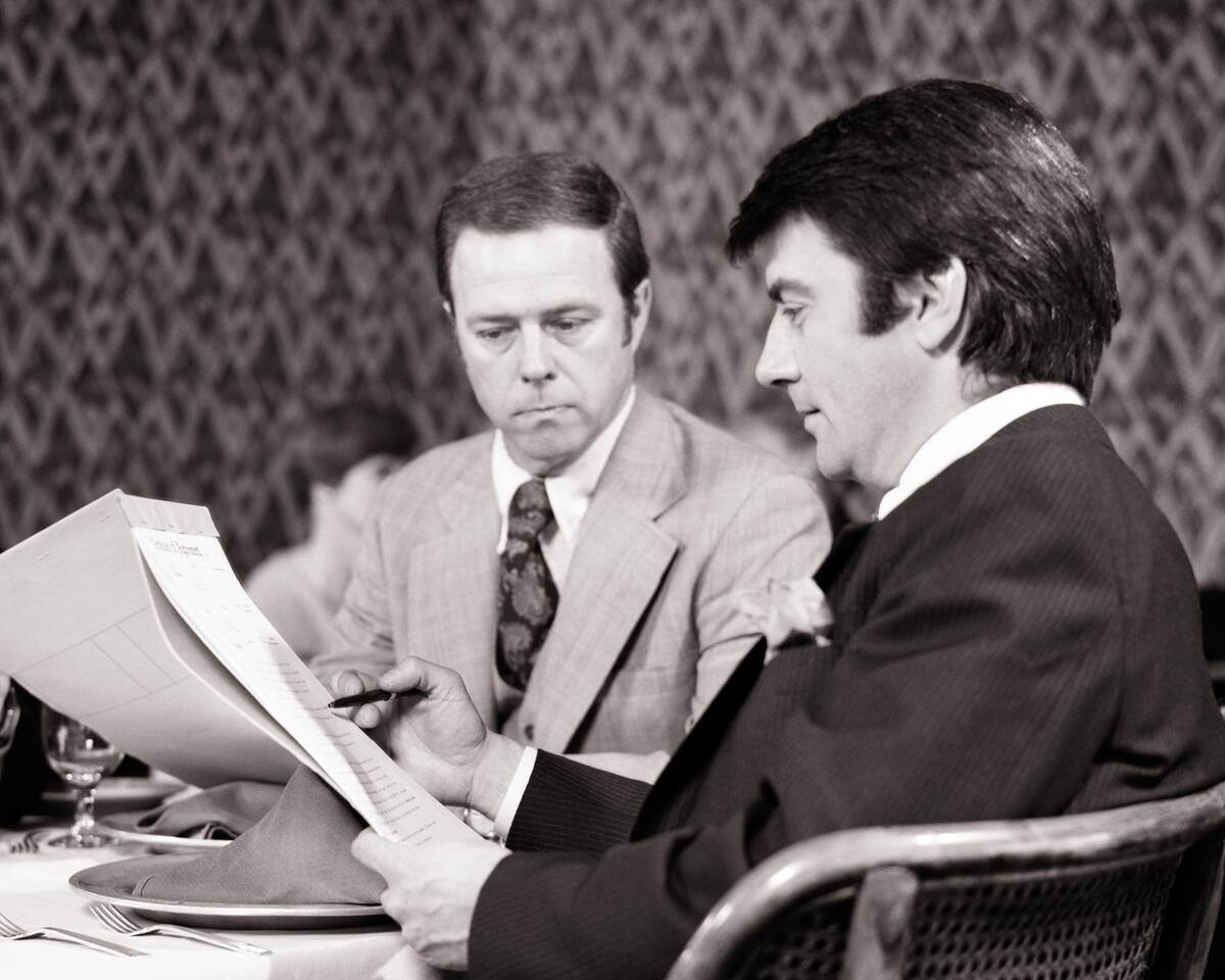 1970s Two Men Reviewing Doc...