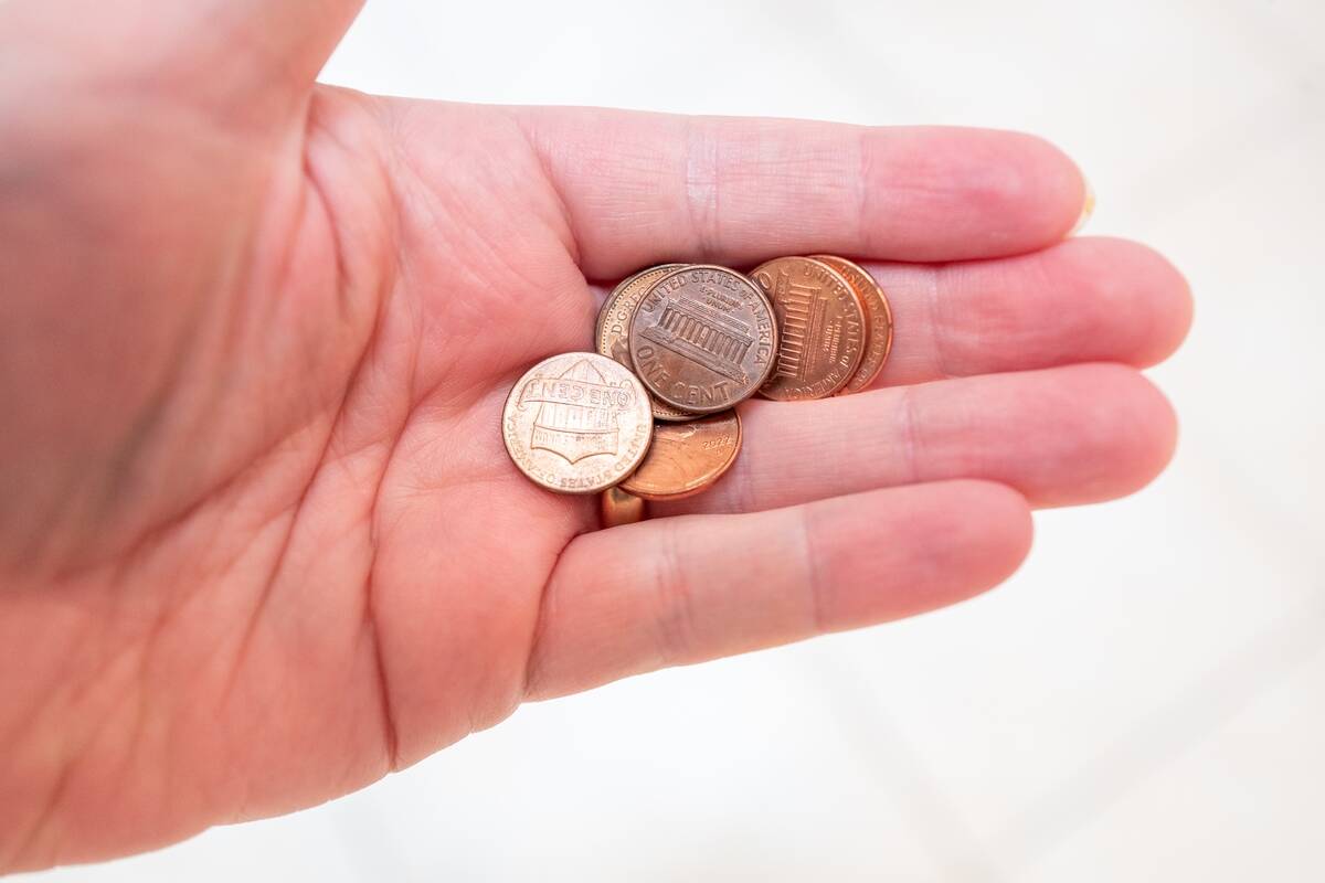 Hand With Pennies And Coins