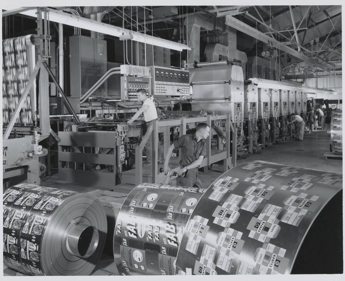 Men Rolling Out Aluminum Foil