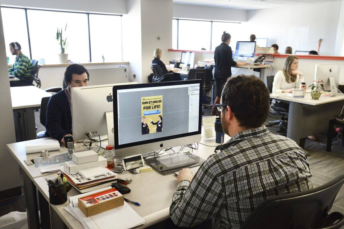 Web designer Aaron Mitchell (foreground) is among a group of young talent working at Liquid Wireless