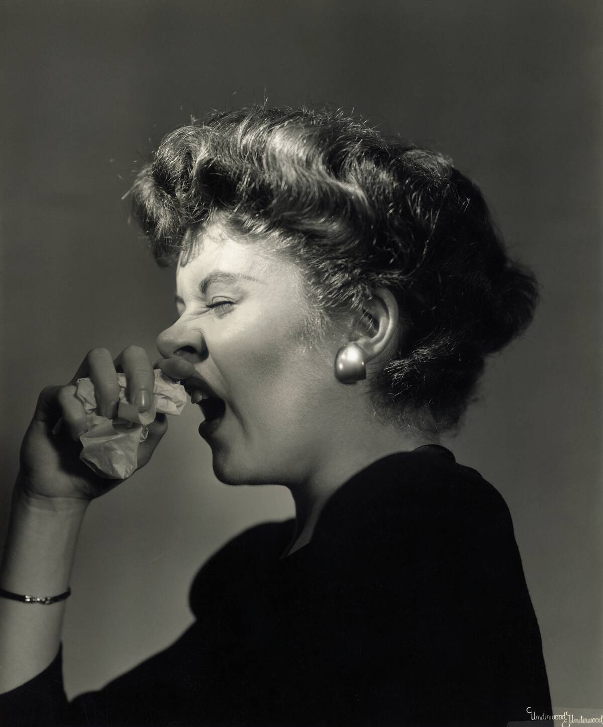 Woman Sneezing with Handkerchief