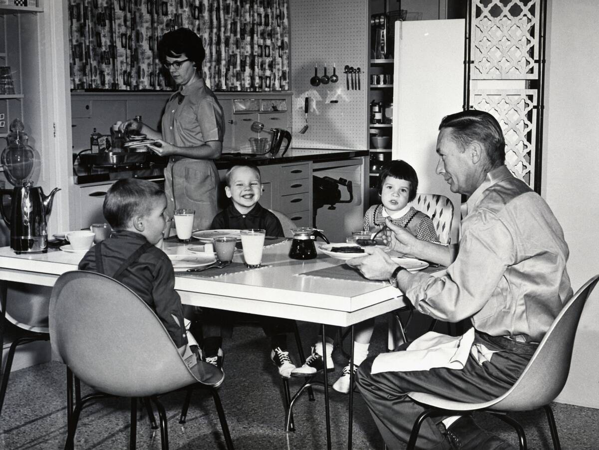 Young Family Eating Breakfast in Kitchen
