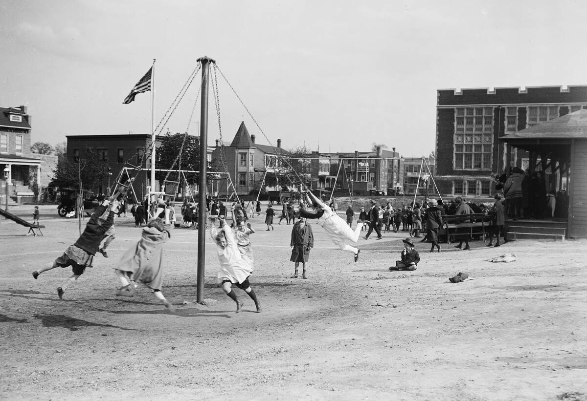 Children playing on a playground ca. May 1924