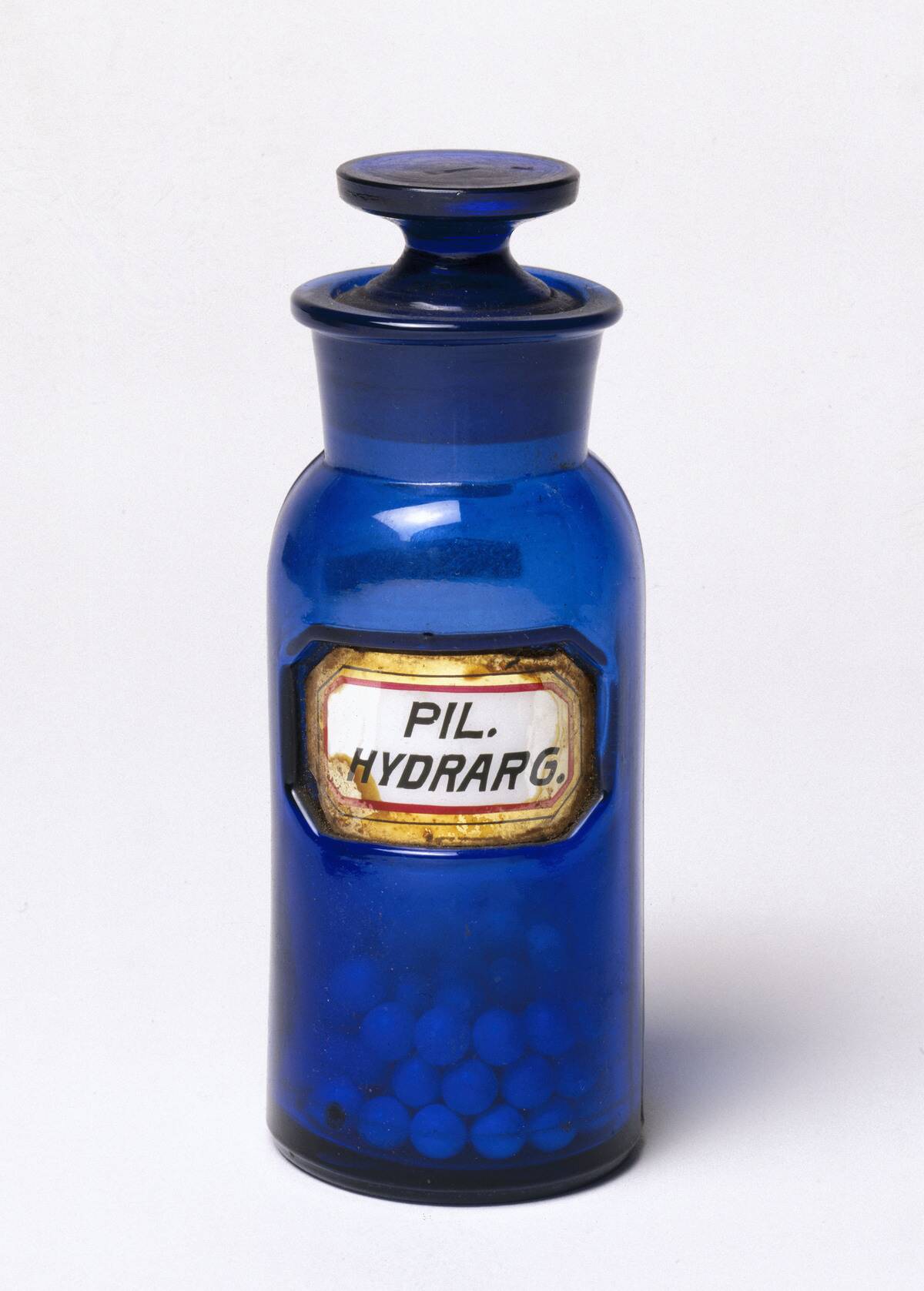Dark blue stoppered glass bottle, English, 1862-1865.