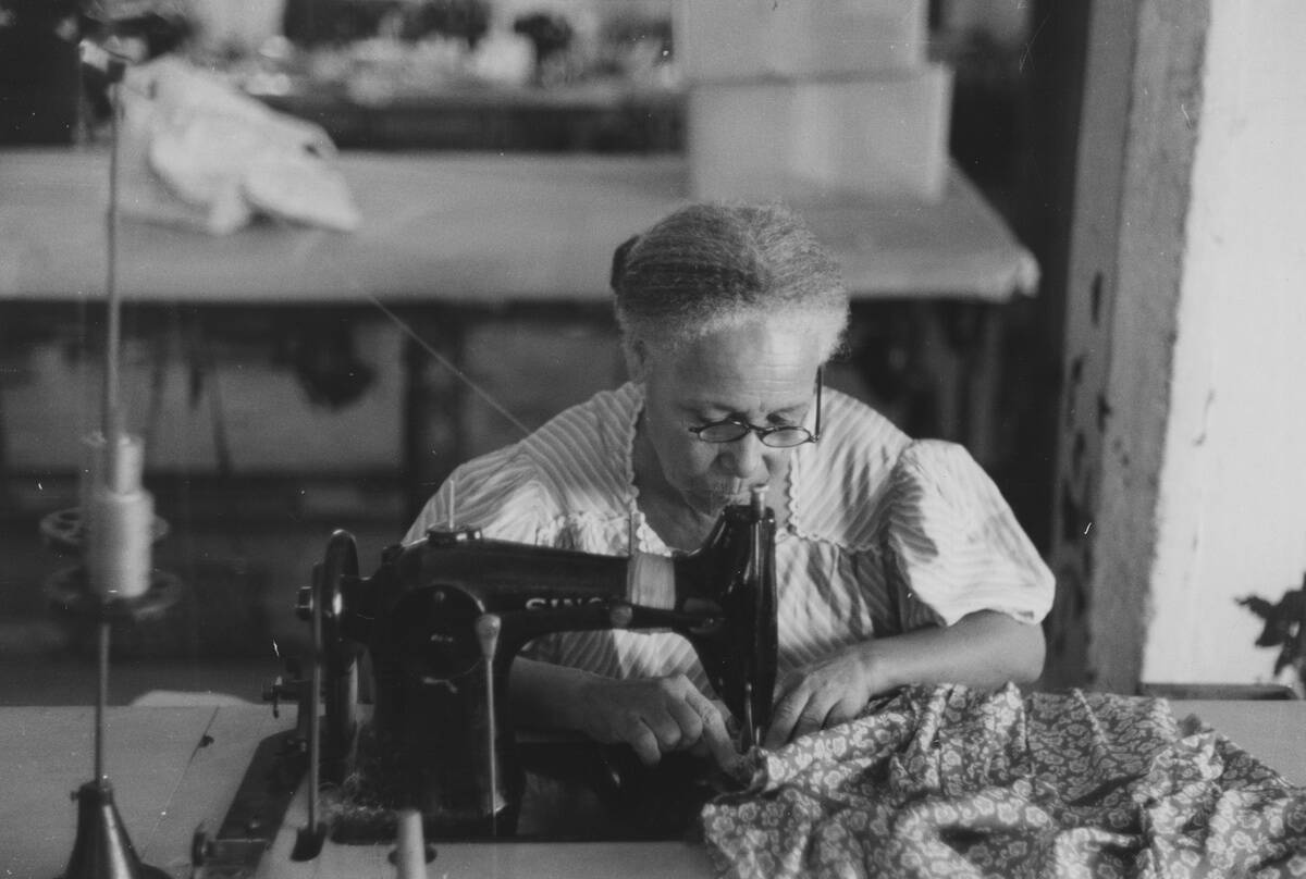 Mature Woman At Sewing Machine