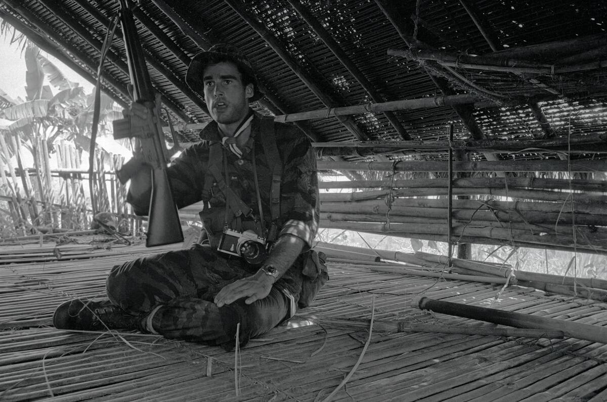 Sean Flynn Sitting with Rifle