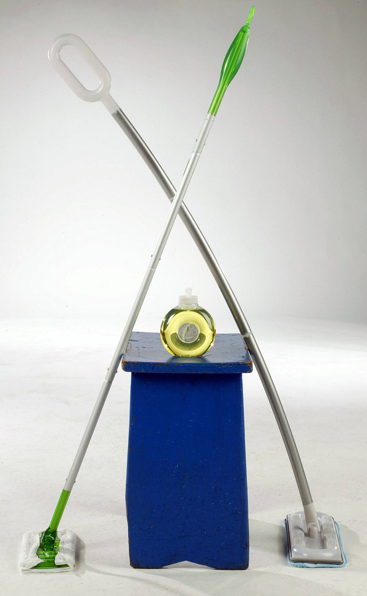 The Swiffer mop, left, comes with wet or dry disposable clot