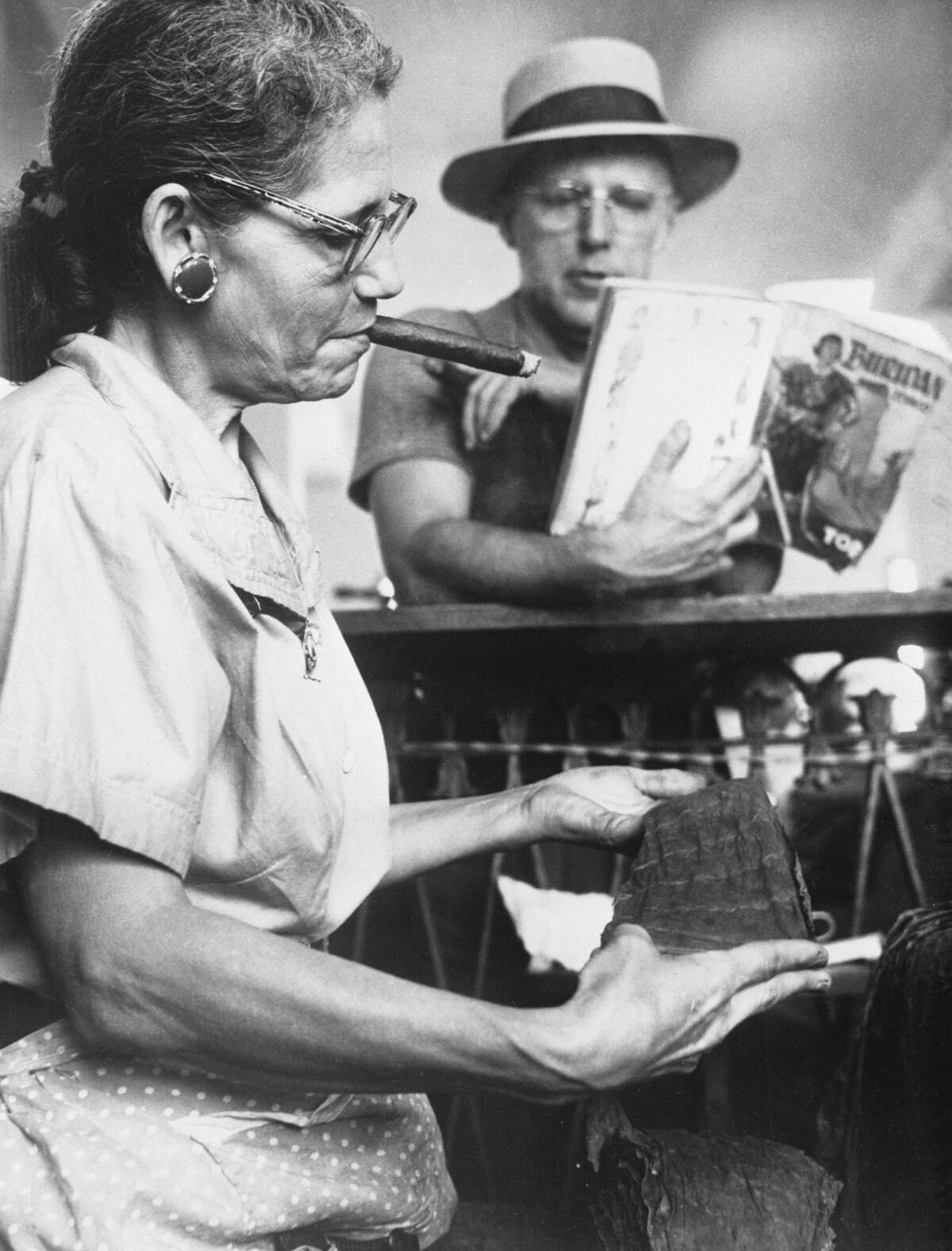 Woman Smoking and Rolling Cigars at Factory