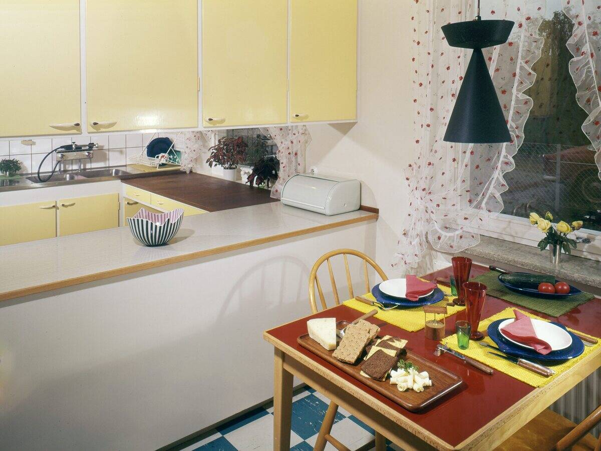 A kitchen in the early 1960s. A kitchen with a separate dining area where there is a kitchen table wit...