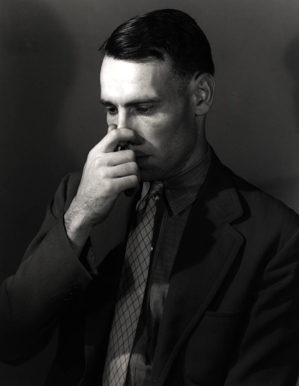 Man Holding His Nose