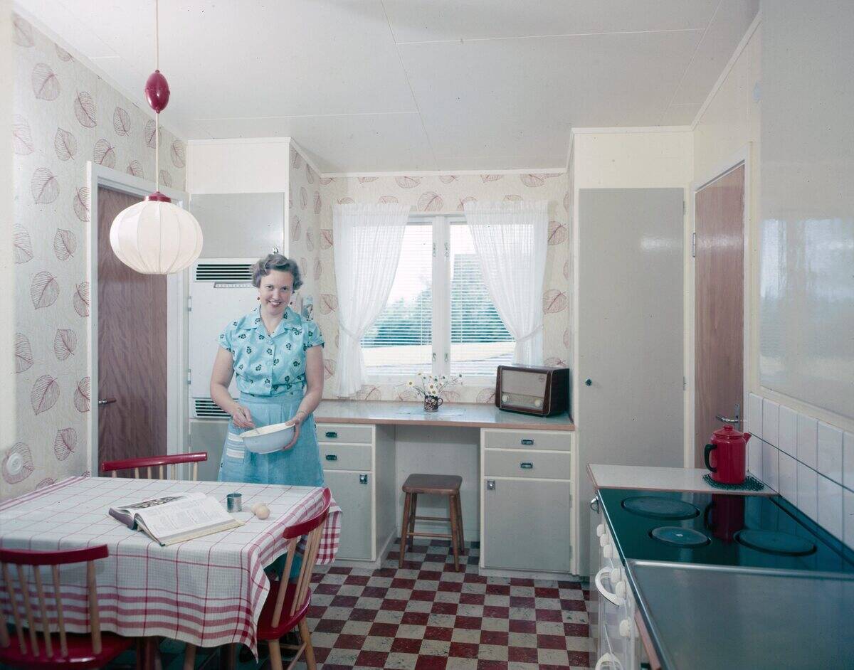 Radio listeners in the past. A woman in the kitchen is whipping up something in a bowl at the kitchen ...