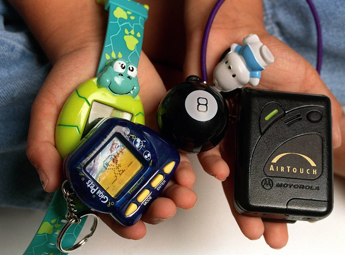 SCHOOLS 29e/C/21AUG97/CD/LH--LEFT TO RIGHT--Giga pets (virtual pets), eight ball keychain, and Santio's bungee pager holder (all back to school items for students). Photo by Liz Hafalia