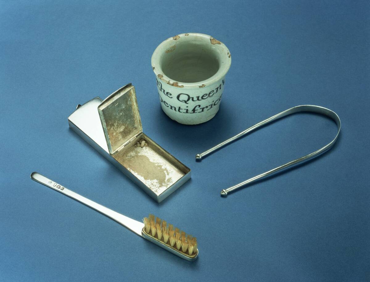 Toothbrush, box of dental powder and tongue-scraper, 18th century.